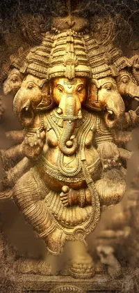 This phone live wallpaper showcases a golden wood carved relief of an art nouveau elephant statue decorated with Indian deity Narasimha