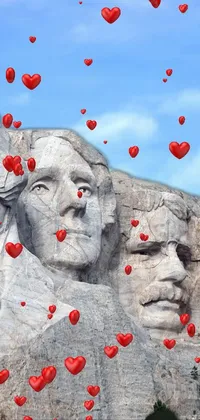 This striking phone live wallpaper portrays a magnificent statue of famous historical faces carved into a mountain