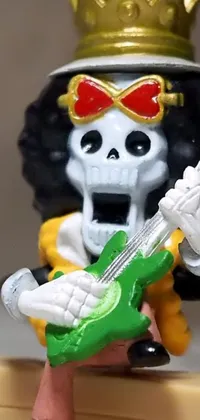 This live wallpaper features a highly detailed figurine of a skeleton playing an electric guitar, accompanied by a stylized depiction of Harley Quinn in the background