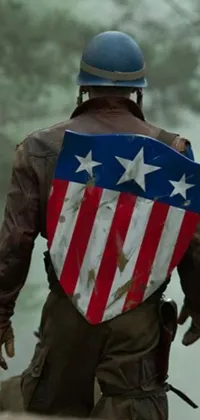 This phone live wallpaper showcases a heroic man holding an American flag shield in brown, red, and blue colors