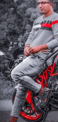 This live wallpaper for phones showcases a striking image of a man on a vibrant red motorcycle