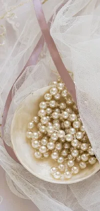 Indulge in the opulence of this live wallpaper! Adorn your phone screen with a white bowl overflowing with dreamy pearls