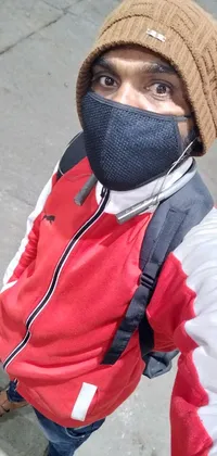 This phone live wallpaper features a person wearing a face mask, taking a selfie on their phone