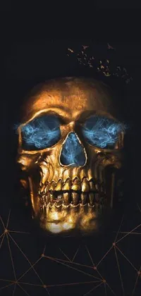 This phone live wallpaper features a mesmerizing digital art piece depicting a gold-colored skull with piercing blue eyes on a black background