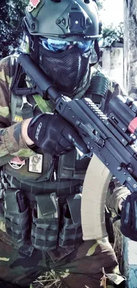 This captivating phone live wallpaper features a man dressed in camouflage and holding a machine gun