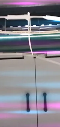 This phone live wallpaper features a computer keyboard sitting on a desk, set against a silk screen with holographic elements and purple tubes