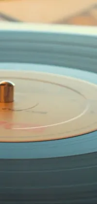 This stunning phone live wallpaper is a close-up of a record on a table
