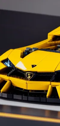 Set your phone apart with this vibrant live wallpaper featuring a yellow Lego sports car model