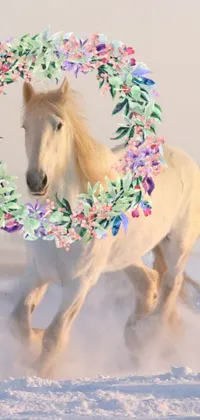 This beautiful live wallpaper depicts a white horse galloping through a snow-covered field, wearing a floral crown and laurel wreath, surrounded by falling snowflakes
