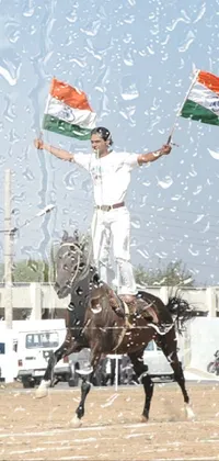 This live phone wallpaper features a man triumphantly riding a brown horse while holding a flag and accompanied by an all-white horse