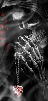 This live wallpaper features the close-up of a hand holding a rosary, with bone jewelry adorning the fingers and wrist
