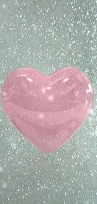This animated phone wallpaper showcases a stunning pink heart-shaped object floating in mid-air