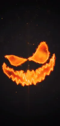 This phone live wallpaper features a glowing pumpkin face on a black background, ideal for those who seek a bold and daring design