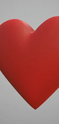 Transform your phone's home screen with this stunning live wallpaper featuring a beautiful red heart-shaped balloon