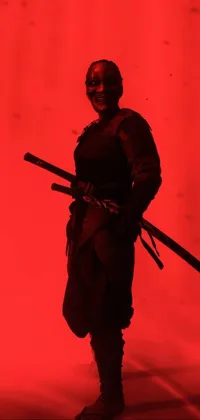 This live phone wallpaper is a breathtaking image of a warrior holding a sword in front of a vibrant red background