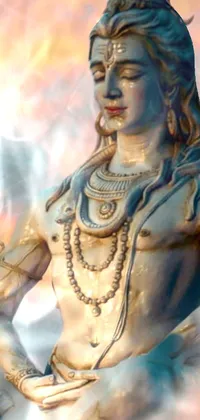 Enjoy this stunning live wallpaper showcasing a close-up of a statue of a Hindu deity thought to be Lord Shiva