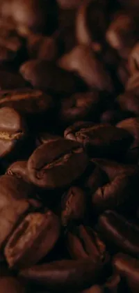 Upgrade your phone screen with our stunning live wallpaper featuring a pile of roasted coffee beans