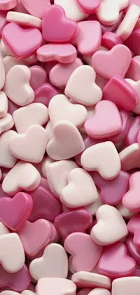 This live phone wallpaper is adorned with a vibrant assortment of pink and white hearts, arranged in a delightful pile