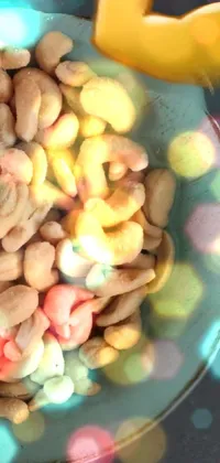 Phone live wallpaper featuring a bowl of cashews on a wooden table