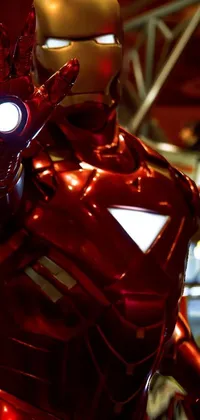 This incredible live wallpaper for your phone features a stunning, up-close image of a person wearing a recognizable Iron Man costume in a triumphant pose