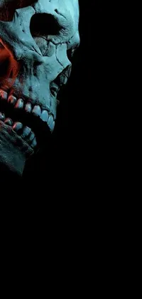 This live wallpaper features a digital art close-up of a skull in a claymation style on a black background with red hues and a massive grin