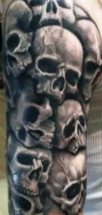 This live phone wallpaper showcases a striking skull tattoo on a woman's arm