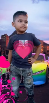This vibrant live wallpaper depicts a young boy in front of a multi-colored car, framed by a backdrop of pink hearts