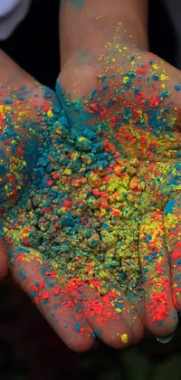 This live wallpaper features a dynamic photo of a colorful powder being thrown into the air, against a stunning cyan and orange palette
