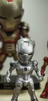 This live wallpaper features a group of Iron Man figurines sitting on a wooden table
