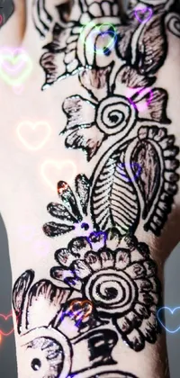 This phone live wallpaper features a close-up of a hand adorned with intricate henna designs