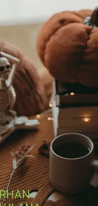 Looking for a unique phone live wallpaper? Check out this cozy and peaceful image of a skeleton sitting on a pile of books with a cup of coffee nearby