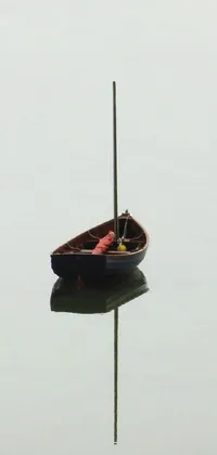 This phone wallpaper features a serene image of a small boat floating on a still body of water