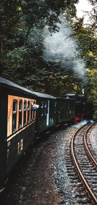 This live wallpaper depicts a vintage steam train chugging down train tracks amidst a lush forest landscape