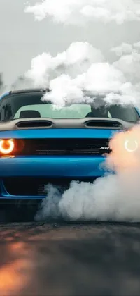 This stunning phone live wallpaper showcases a blue car with voluminous smoke emanating from its exhaust pipes