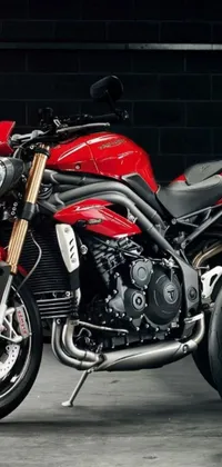 This stunning phone live wallpaper showcases a parked red and black motorcycle in a dimly-lit garage