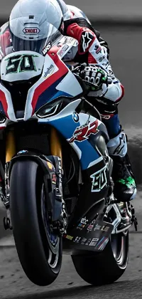 This live wallpaper for mobile devices features a high-energy image of a motorcycle rider on a race track