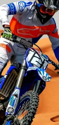 Get ready for some high-octane action with this phone live wallpaper that features a dirt bike racer tearing through the desert