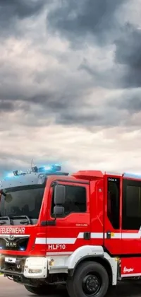 This live wallpaper features a vivid red fire truck speeding down a road