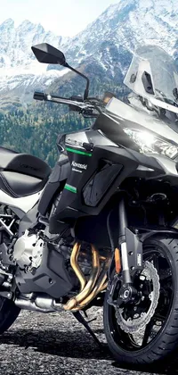 This phone live wallpaper boasts an impressive photorealistic image of a motorcycle amidst a captivating mountain range with a black and green colour scheme