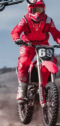 Looking for a live wallpaper that will add an adrenaline boost to your device? This dirt bike rider live wallpaper features a male rider dressed in red sportswear, taking his dirt bike to full speed