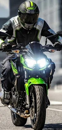Get ready to hit the open road with this stunning live wallpaper that features a green Kawasaki motorcycle with a rider on its back