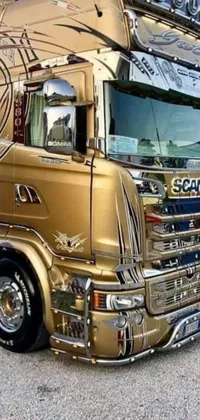 This phone live wallpaper showcases a stunning gold semi-truck parked in a lot with gleaming silver and rich colors