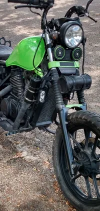 Looking for a cool new wallpaper for your phone? Check out this mad max inspired motorcycle parked in a gritty parking lot! Featuring a bold green color, this motorcycle is viewed from the front to showcase its powerful engine