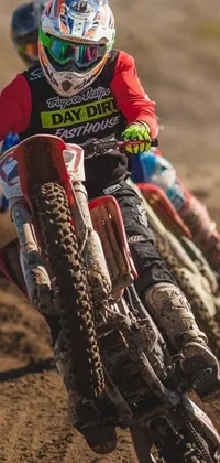 Get the ultimate live wallpaper for your phone with this thrilling image of a dirt biker tearing up a dirt track