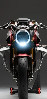 Looking for a stunning live wallpaper to personalize your phone? Look no further than this captivating image of a motorcycle with a bright light beaming from the front
