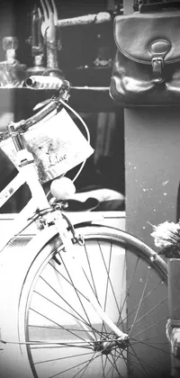 Upgrade your phone display with this breathtaking black and white live wallpaper featuring a classic bicycle parked next to a vintage suitcase