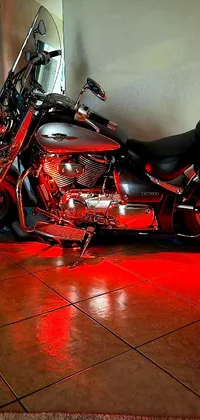 Looking for an edgy and stylish wallpaper for your phone? Check out this close-up of a motorcycle parked on a tiled floor