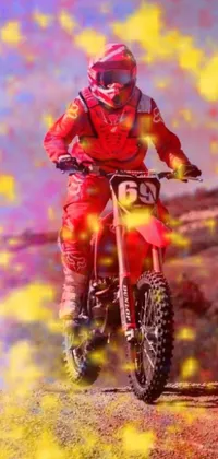 This dynamic live wallpaper for your phone features a digital image of a dirt bike rider on a dirt road, painted in a bold red and yellow color scheme
