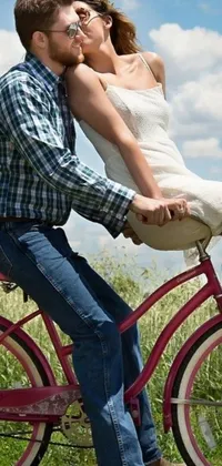 This phone live wallpaper displays a beautiful and romantic scene of a man seated on a bike, holding tight from behind to a woman while their legs are intertwined