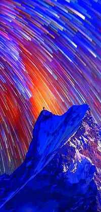 This phone live wallpaper depicts a stunning mountain range against a starry night sky